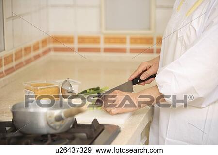 Stock Photo - Human Hand cooking miso soup. Fotosearch