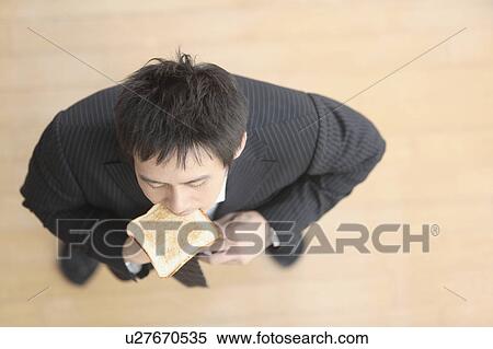 Mid adult man dressing and eating View Large Photo Image Stock Photography - Mid adult man dressing and eating. Fotosearch