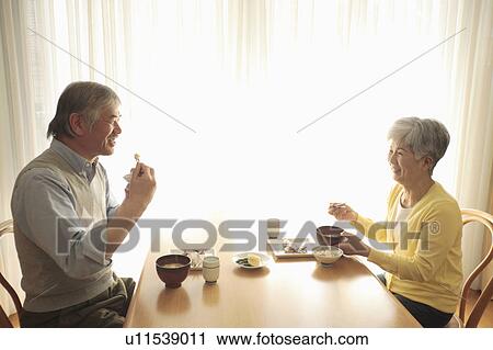 Stock Image - Senior couple having meal. Fotosearch
