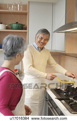 Senior couple standing in kitchen View Large Photo Image Picture - Senior couple standing in kitchen. Fotosearch