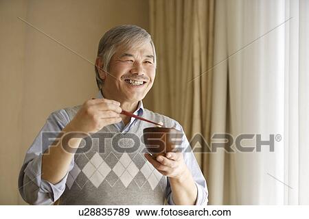 Senior man having meal View Large Photo Image Stock Photo - Senior man having meal. Fotosearch