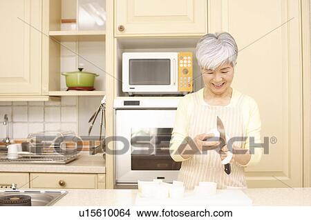 Senior woman cooking View Large Photo Image Picture - Senior woman cooking. Fotosearch