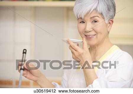 Senior woman cooking View Large Photo Image Stock Image - Senior woman cooking. Fotosearch