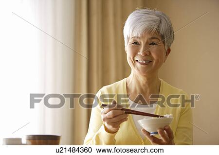Senior woman having meal View Large Photo Image Stock Image - Senior woman having meal. Fotosearch