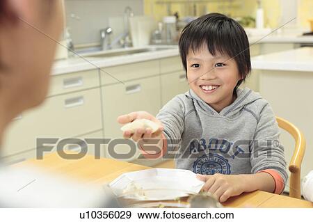 Boy cooking pot-sticker View Large Photo Image Stock Photo - Boy cooking pot-sticker. Fotosearch