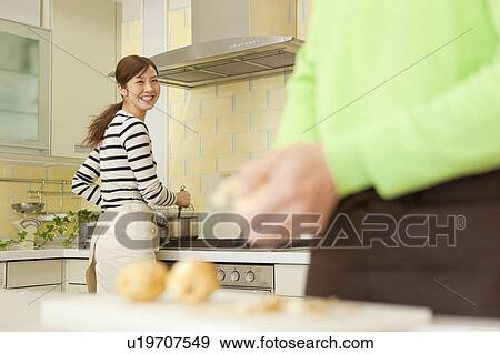 Couple cooking in kitchen View Large Photo Image Stock Photo - Couple cooking in kitchen. Fotosearch