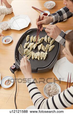 Couple cooking pot-sticker View Large Photo Image Stock Photo - Couple cooking pot-sticker. Fotosearch