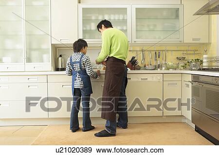 Stock Photo - Father and son cooking. Fotosearch