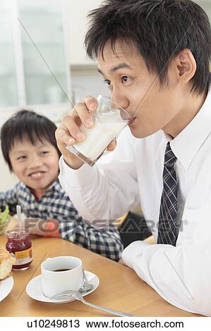 Father and son having breakfast View Large Photo Image Stock Image - Father and son having breakfast. Fotosearch