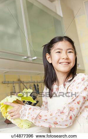 Girl cooking in kitchen View Large Photo Image Stock Photograph - Girl cooking in kitchen. Fotosearch