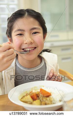 Girl eating curry and rice View Large Photo Image Stock Image - Girl eating curry and rice. Fotosearch
