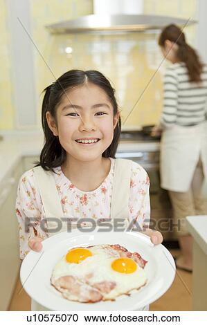 Girl holding plate of bacon egg View Large Photo Image Stock Image - Girl holding plate of bacon egg. Fotosearch