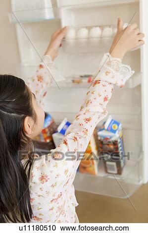 Girl taking out egg from refrigerator View Large Photo Image Stock Image - Girl taking out egg from refrigerator. Fotosearch