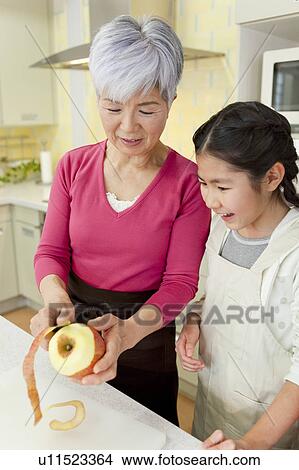 Grandmother cooking with granddaughter View Large Photo Image Picture - Grandmother cooking with granddaughter. Fotosearch