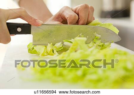 Picture - Human Hand cooking. Fotosearch