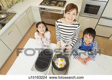 Mother and children cooking View Large Photo Image Picture - Mother and children cooking. Fotosearch