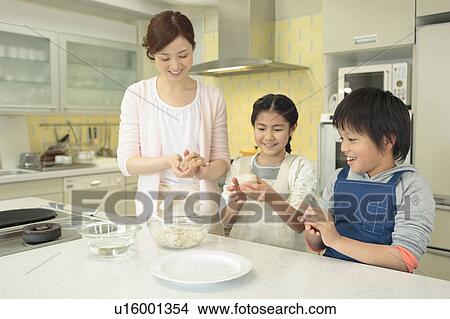 Mother and children cooking rice ball View Large Photo Image Picture - Mother and children cooking rice ball. Fotosearch