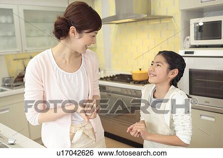Stock Photograph - Mother and children cooking rice ball. Fotosearch