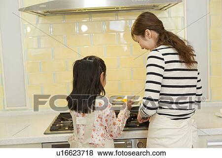 Mother and daughter cooking View Large Photo Image Stock Photo - Mother and daughter cooking. Fotosearch