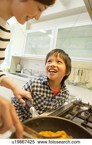 Stock Photography - Mother and son cooking. Fotosearch