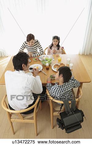 Parents and children having breakfast View Large Photo Image Stock Photography - Parents and children having breakfast. Fotosearch