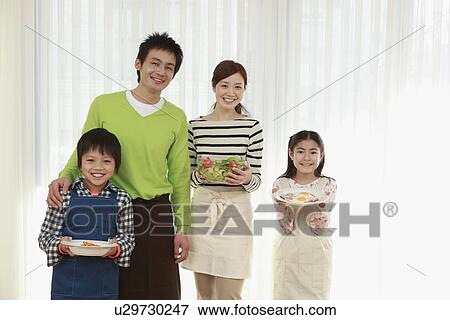 Parents and children holding breakfast dishes View Large Photo Image Stock Photo - Parents and children holding breakfast dishes. Fotosearch