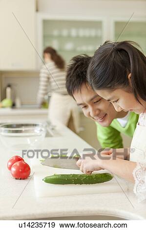 Parents and daughter cooking View Large Photo Image Stock Photo - Parents and daughter cooking. Fotosearch