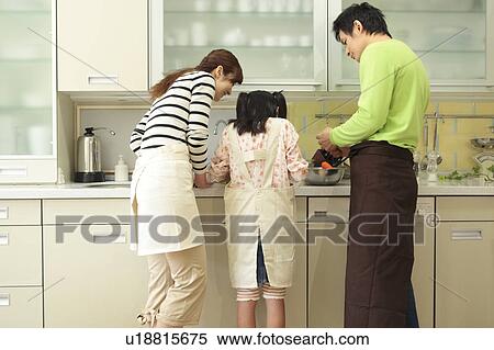 Parents and daughter cooking View Large Photo Image Stock Photography - Parents and daughter cooking. Fotosearch