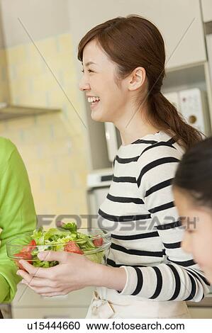 Young woman holding salad bowl View Large Photo Image Stock Image - Young woman holding salad bowl. Fotosearch