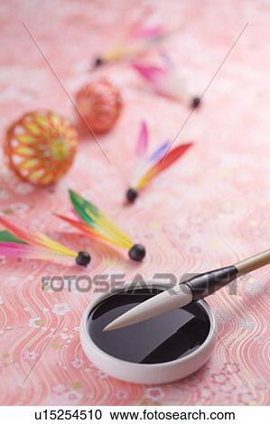 Stock Image - Calligraphy brush and shuttle cock. Fotosearch