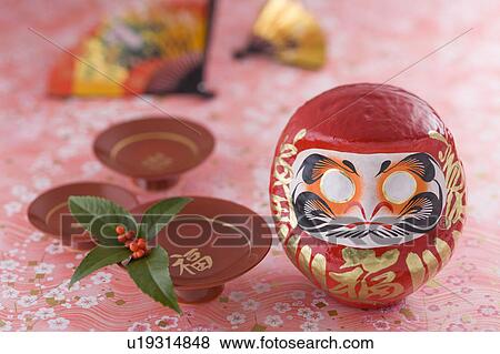 Stock Photo - Daruma doll and sake cup. Fotosearch
