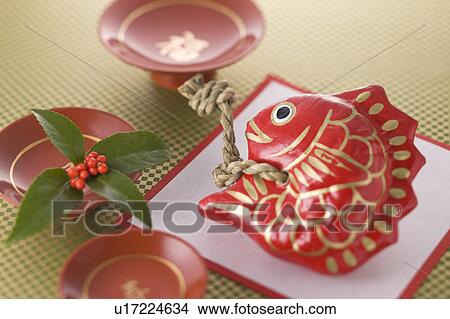 Picture - Fish ornament and sake cup. Fotosearch