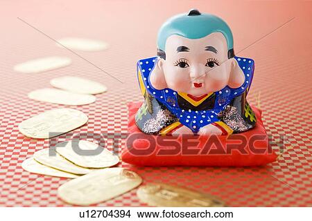 Fukusuke doll and gold coin View Large Photo Image Picture - Fukusuke doll and gold coin. Fotosearch