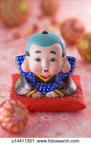 Stock Image - Fukusuke doll and temari ball. Fotosearch