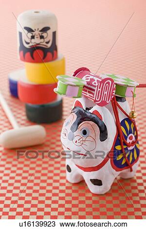 Papier-mâché dog and Daruma doll game View Large Photo Image Stock Image - Papier-mâché dog and Daruma doll game. Fotosearch