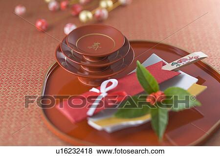 Stock Photo - Sake cup and chopsticks on tray. Fotosearch