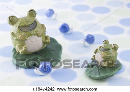 Stock Image - Frog and snail ornament. Fotosearch