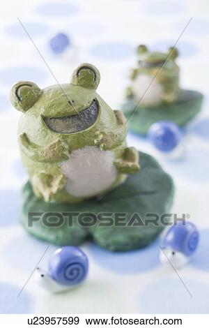 Stock Photo - Frog and snail ornament. Fotosearch