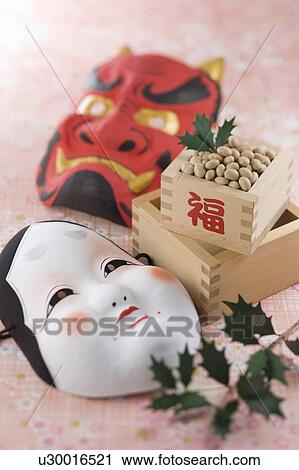 Stock Image - Soybean and mask of evil and plain woman. Fotosearch