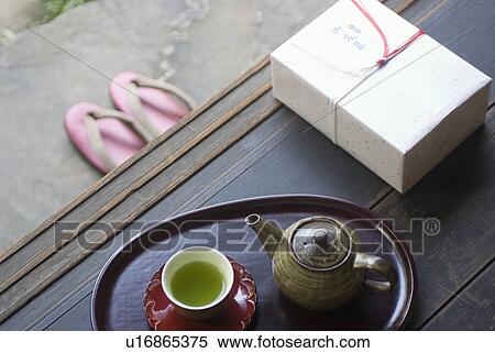 Stock Photography - Gift box and tea cup on veranda. Fotosearch