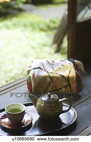 Wrapped gift and tea cup on veranda View Large Photo Image Stock Image - Wrapped gift and tea cup on veranda. Fotosearch
