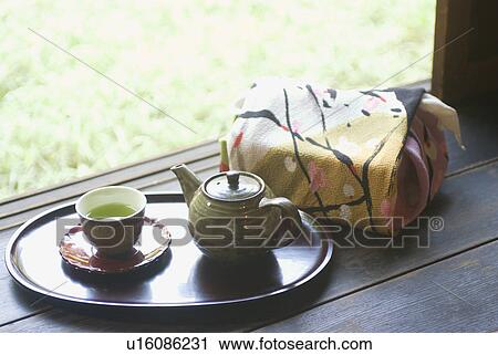Wrapped gift and tea cup on veranda View Large Photo Image Stock Image - Wrapped gift and tea cup on veranda. Fotosearch