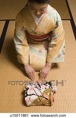 Young woman in kimono greeting View Large Photo Image Stock Image - Young woman in kimono greeting. Fotosearch