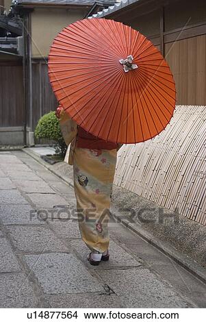Picture - Young woman in kimono holding paper umbrella. Fotosearch