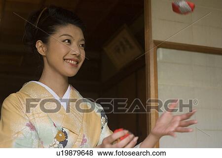 Young woman in kimono playing beanbags View Large Photo Image Stock Photo - Young woman in kimono playing beanbags. Fotosearch