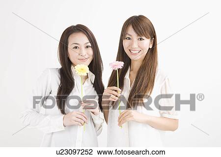 Two young women smiling View Large Photo Image Stock Image - Two young women smiling. Fotosearch