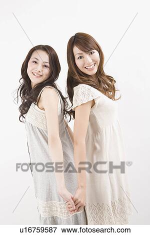 Stock Photo - Two young women standing. Fotosearch