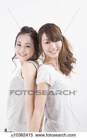 Stock Photography - Two young women standing. Fotosearch