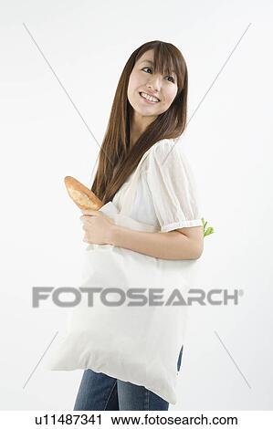 Young woman holding Eco bag View Large Photo Image Stock Image - Young woman holding Eco bag. Fotosearch