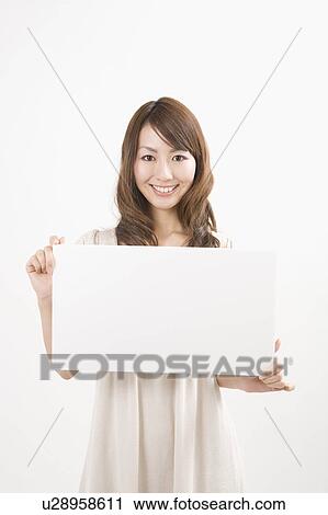 Young woman holding message board View Large Photo Image Stock Image - Young woman holding message board. Fotosearch